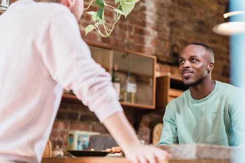 Men Looking at Each Other in a Kitchen 