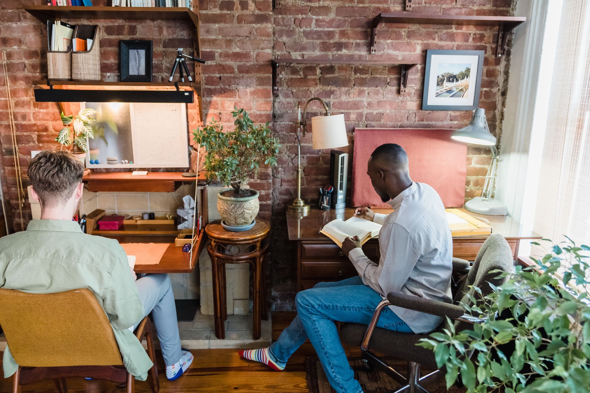 ADHD body doubling focus & productivity adhd — person working at desk friend reading book cozy living room warm lamp