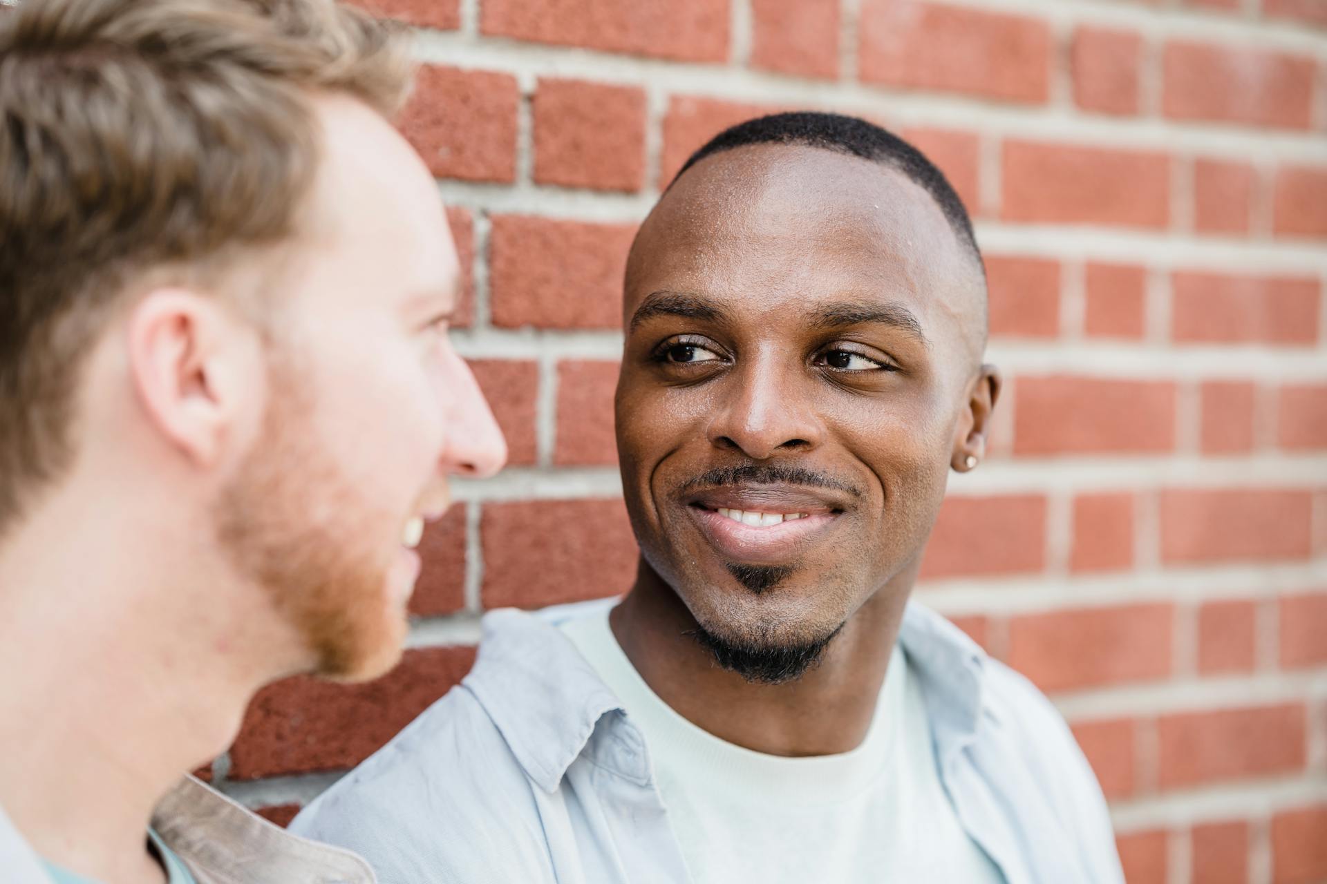 Close-up of Two Men Smiling at each other
