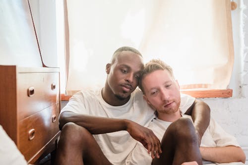 Portrait of Couple Sitting on Bedroom Floor