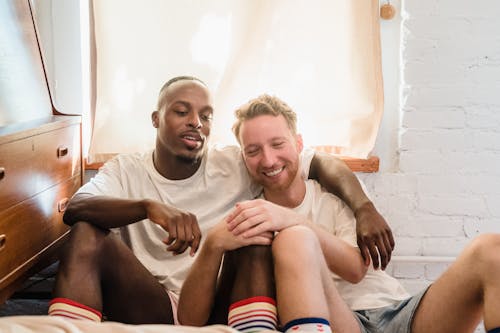 Portrait of Couple Sitting on Bedroom Floor