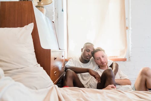 Portrait of Couple Sitting on Bedroom Floor