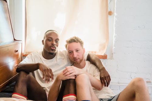 Portrait of Couple Sitting on Bedroom Floor