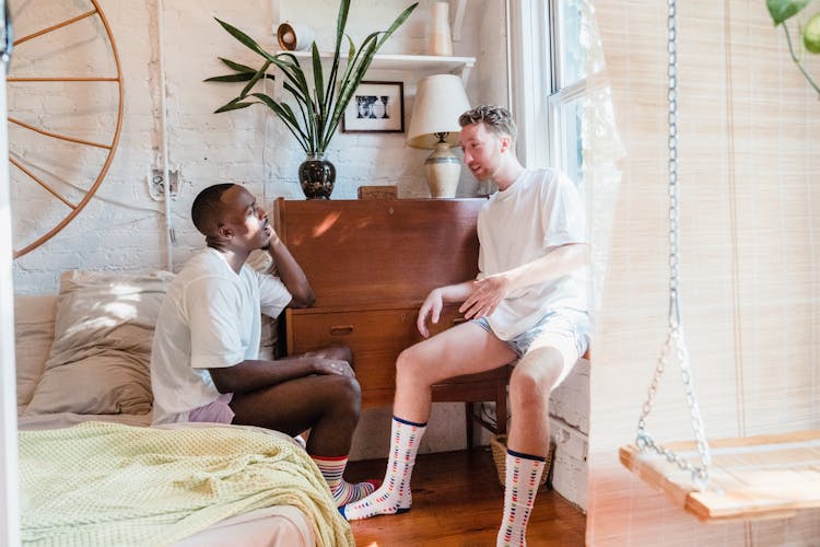 Couple Talking Together In Bedroom