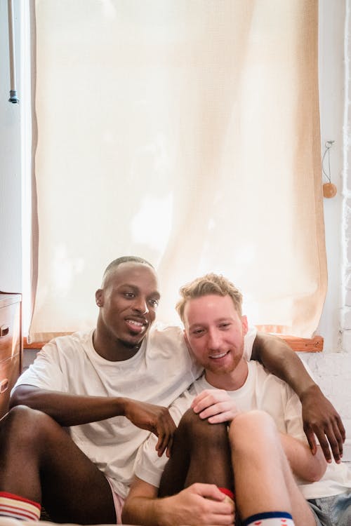 Portrait of Couple Sitting on Bedroom Floor