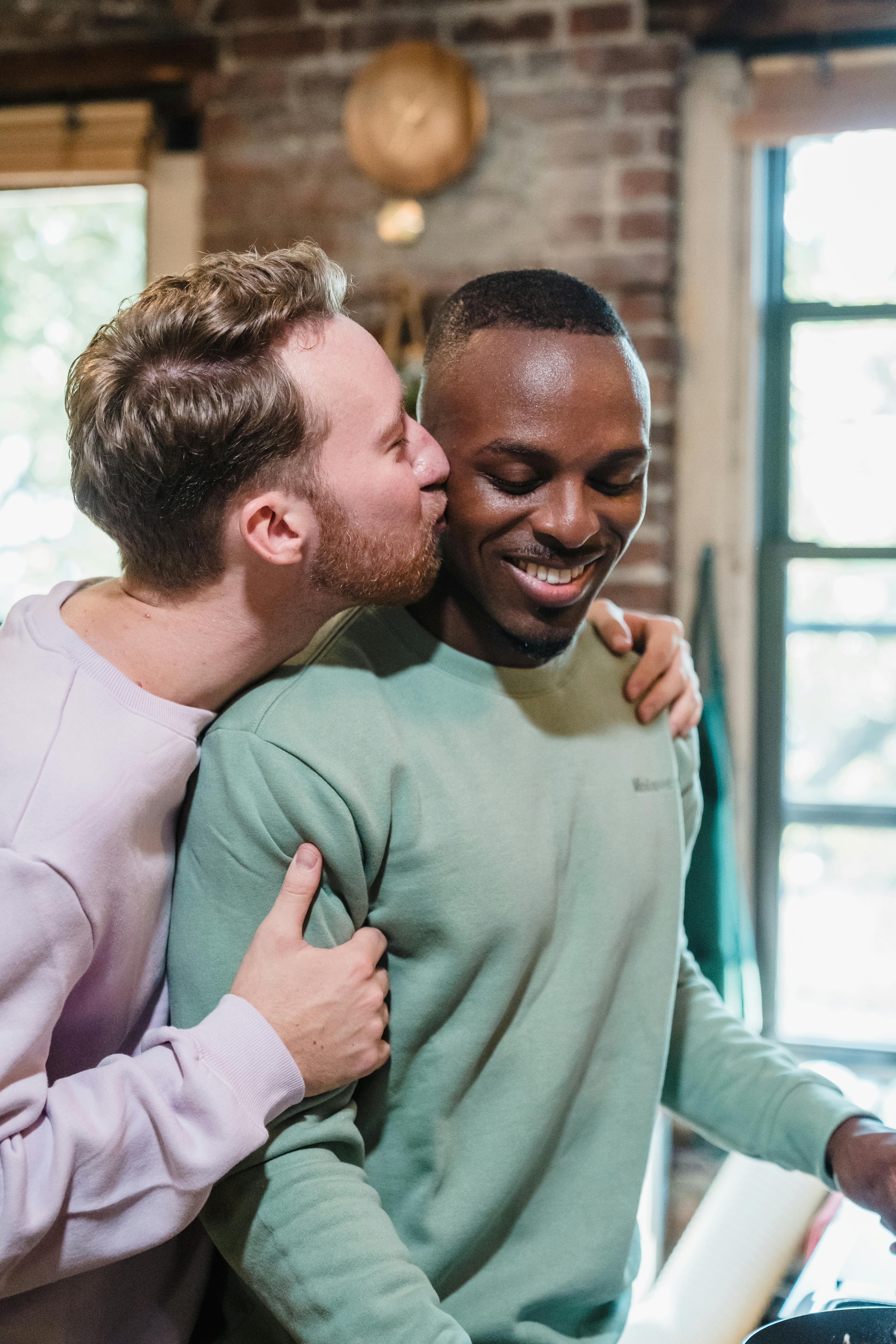 men smiling and kissing