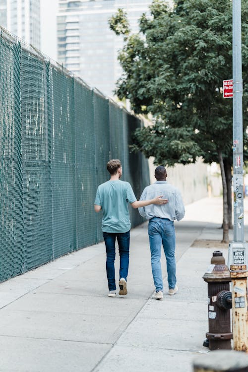 Men Walking on Sidewalk