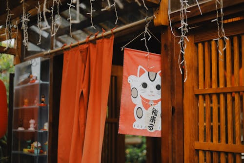 Red Wall Decor and Curtains Hanging on a Wooden Pole