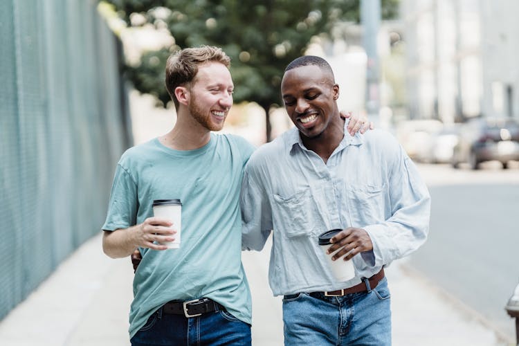 Gay Couple On A Walk Outdoors In City 