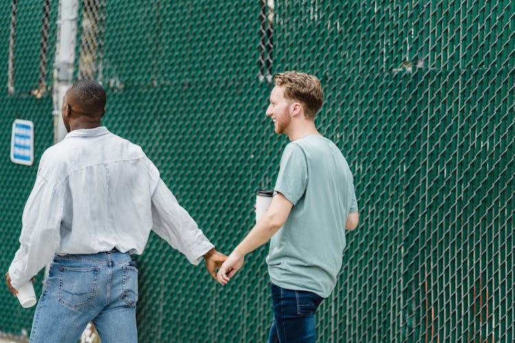 Gay Couple On A Walk Outdoors In City 