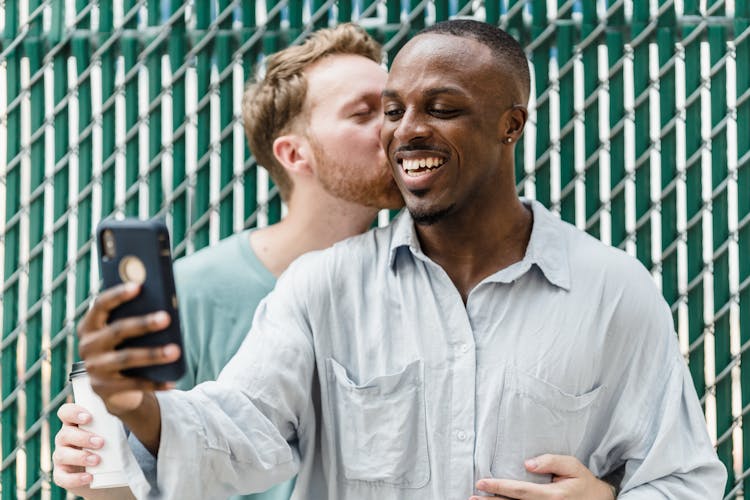 Gay Couple Taking A Selfie Outdoors 