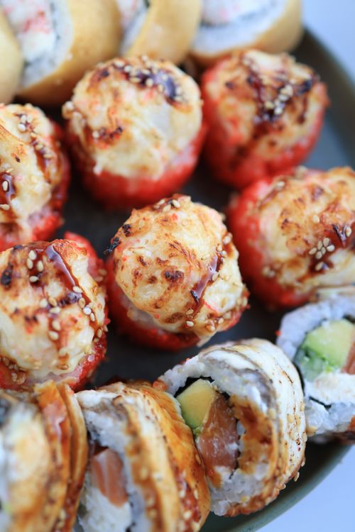 Free Close-up of fresh and delicious sushi rolls topped with sesame seeds, perfect for a gourmet meal. Stock Photo