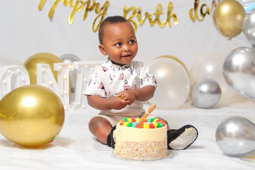 Free Adorable baby celebrating first birthday with cake and balloons. Stock Photo