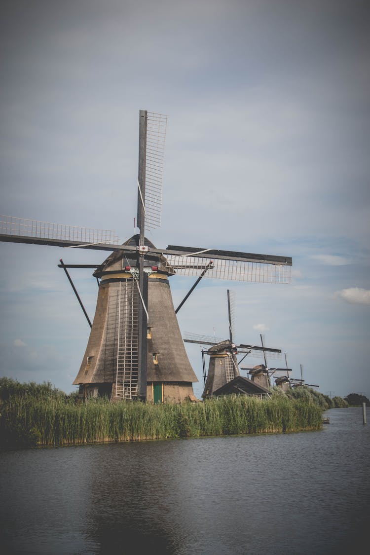 Old Wooden Windmills At The Water In Kinderdijk, Holland