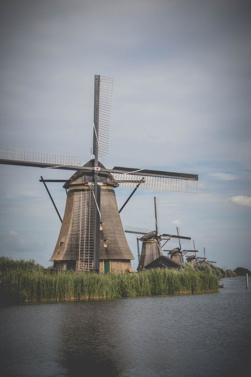 Free Iconic windmills of Kinderdijk on a serene day, showcasing Dutch heritage and UNESCO World Heritage charm. Stock Photo