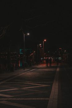 Moody nighttime street view in Istanbul with glowing streetlamps and urban ambiance.