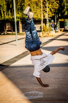 Breakdancer performing a handstand on a sunny day in Mendoza, Argentina.