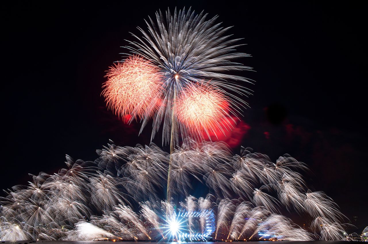 a breathtaking fireworks show with vibrant colors illuminating the nig
