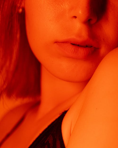 Close-up of Woman in Lingerie in Orange Light