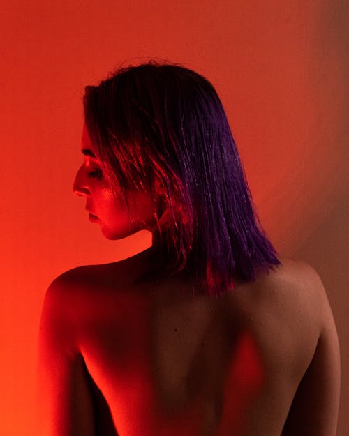 Back View Topless Woman in Red Lighting