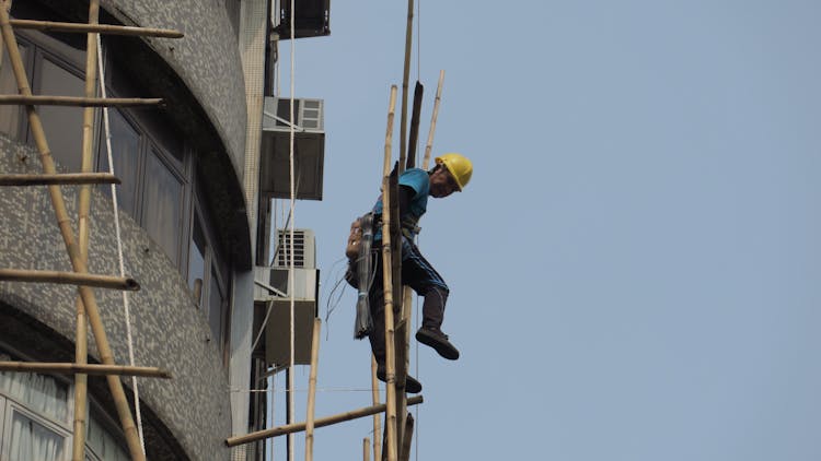 Builder Working On A Scaffolding