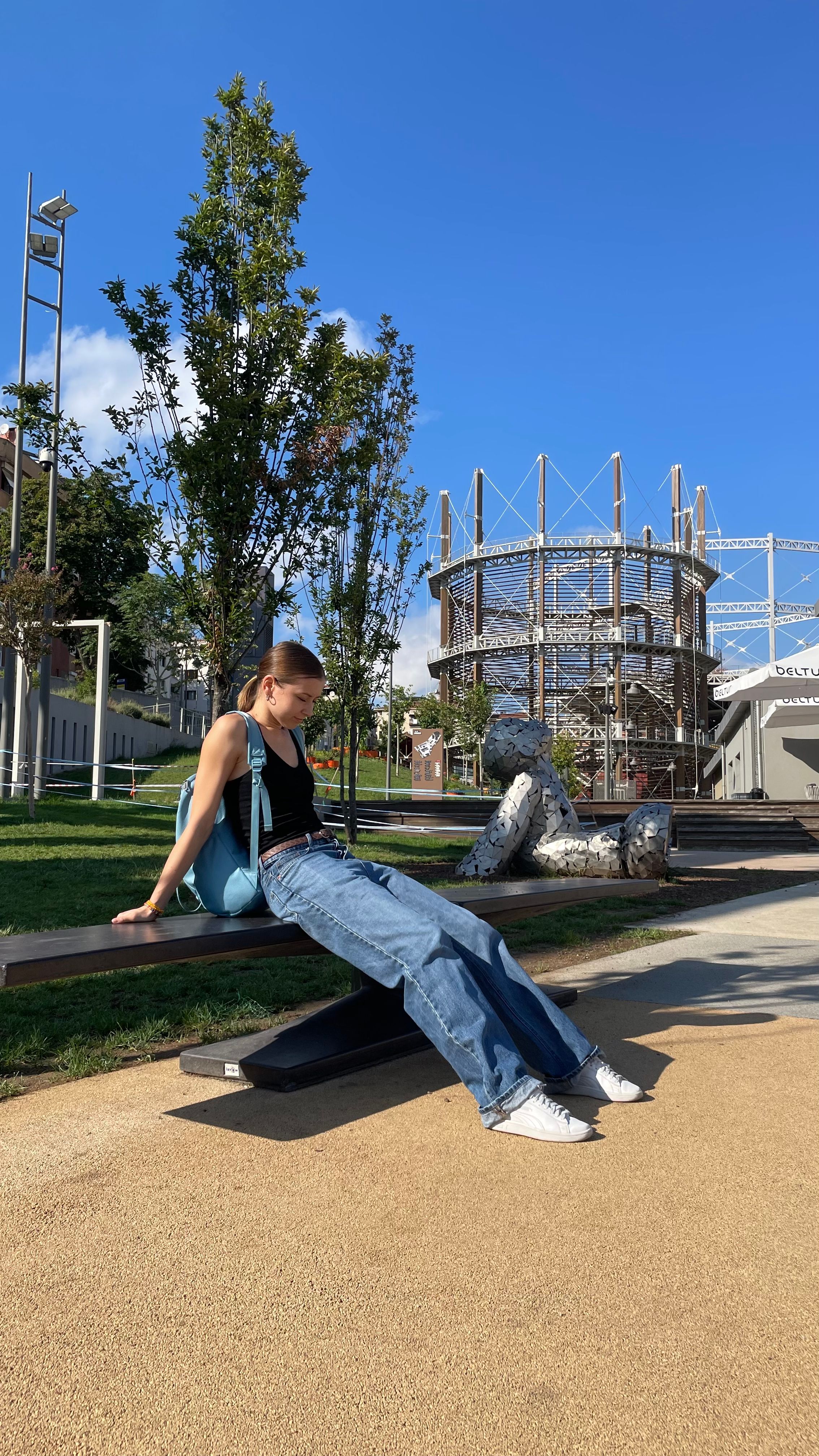 A Woman in Denim Jeans Sitting on the Bench · Free Stock Photo