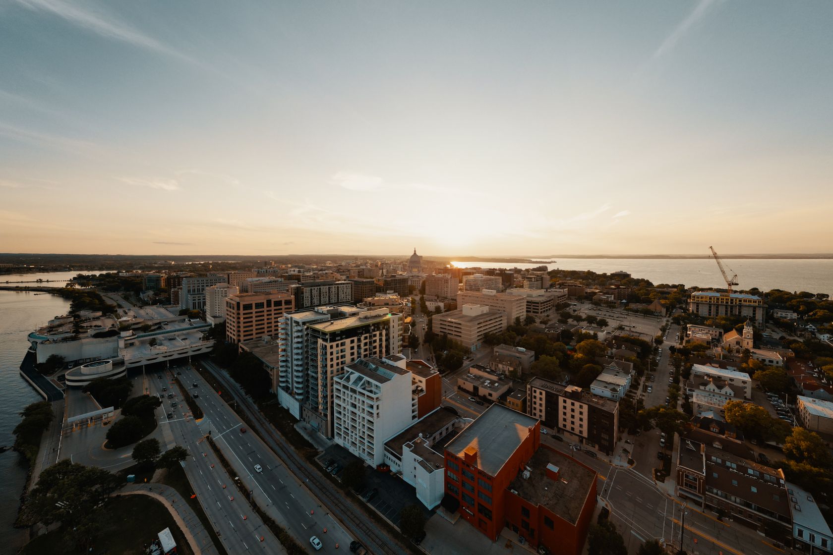 Breathtaking aerial view of Madison, Wisconsin's cityscape during a serene sunset.