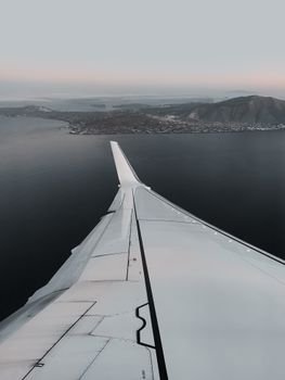 Breathtaking aerial view of Greece's coastline from an airplane window.