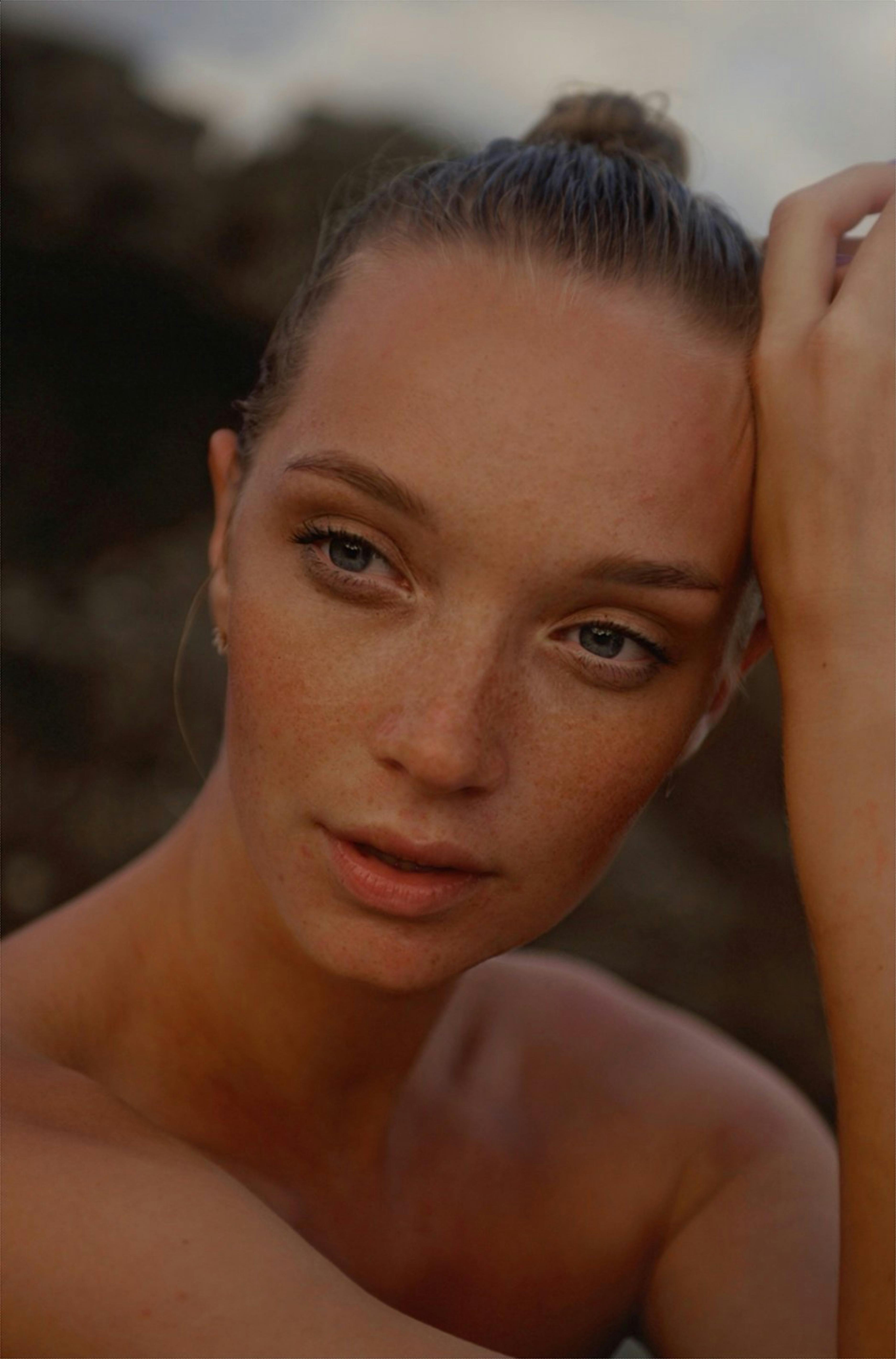 Close-up portrait of a woman with a natural look and soft lighting.