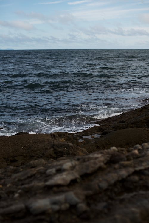 Sea Waves Crashing on Brown Sand on the Shore