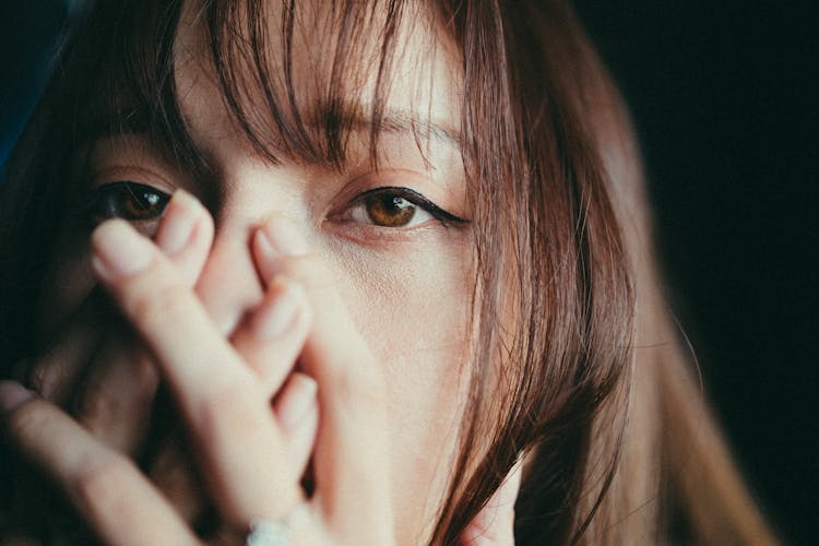 Close-up On Woman Covering Face With Hands