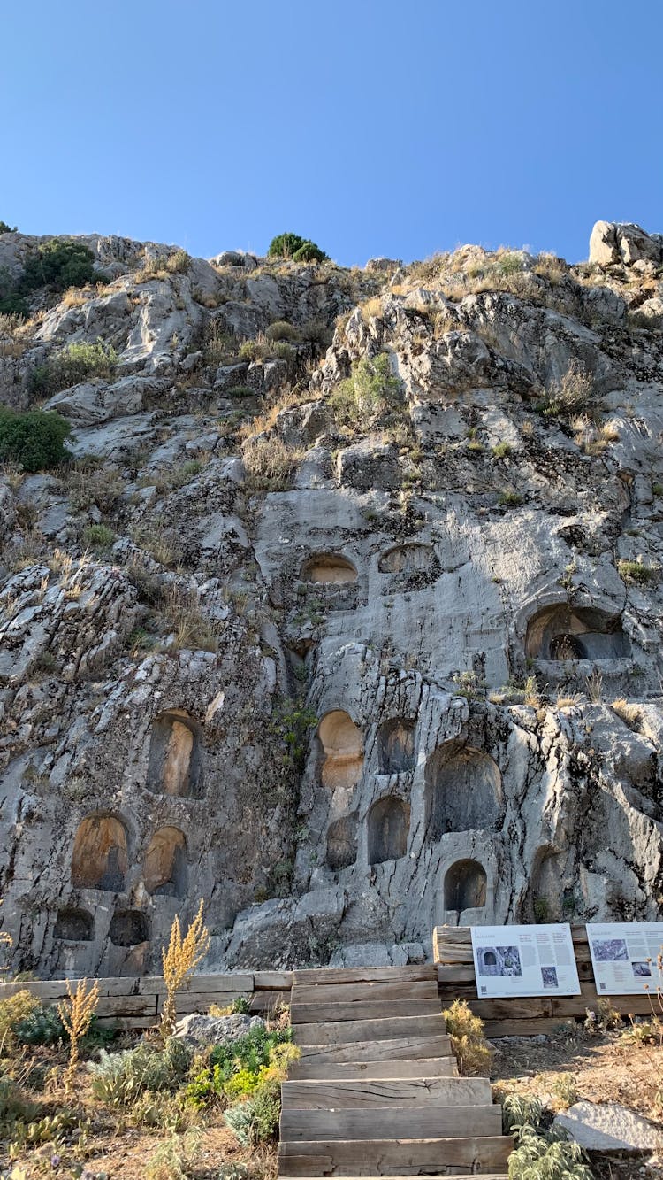 Ancient Rock Caves On Blue Sky Background