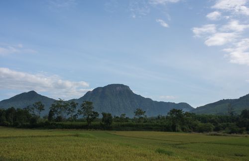 Free Peaceful mountain scenery with clear sky and lush green fields, offering a tranquil view. Stock Photo