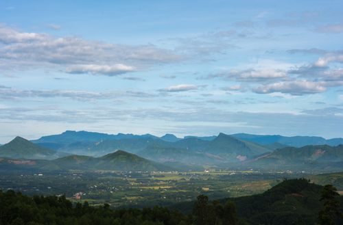 Free Breathtaking scenic view of mountains under a partly cloudy sky, capturing vibrant natural beauty. Stock Photo
