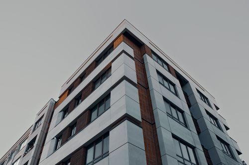 Free Perspective view of a modern apartment building in Mashhad, Iran, under a gray sky. Stock Photo