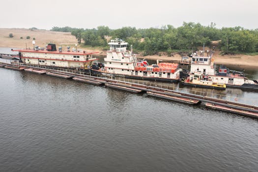 Aerial view of barges and towboats on a river in Trevino, WI, showcasing water transportation.