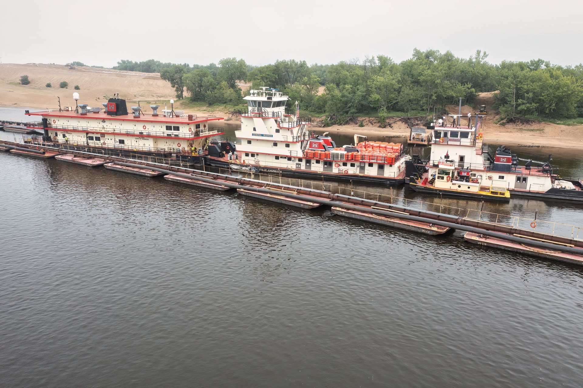 Aerial view of barges and towboats on a river in Trevino, WI, showcasing water transportation.