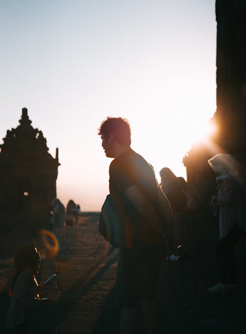 Selective Focus Photo of Man Standing in Front of Child