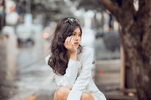 Beautiful Woman with Curly Hair with Hand on Chin