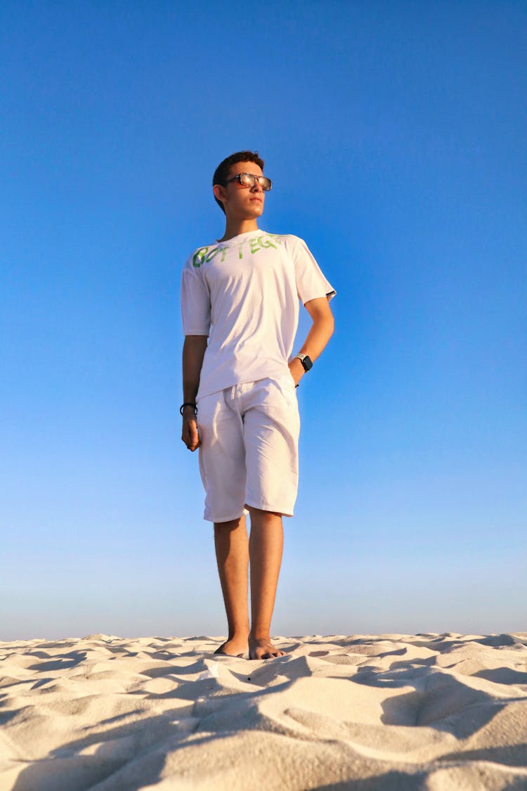 Man In Sunglasses Standing On A Beach