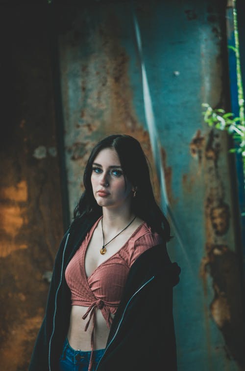 A Woman Wearing a Crop Top and Black Jacket