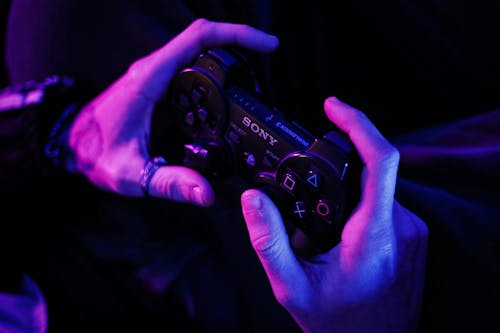 Person Holding a PlayStation Control