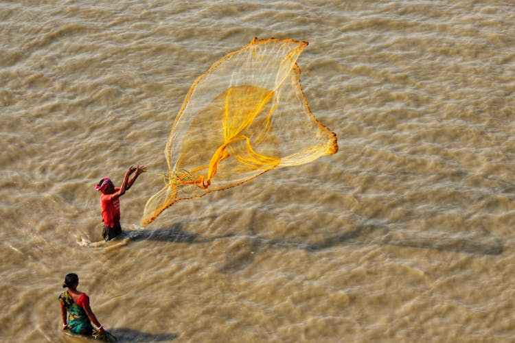 A Fisherman Throwing The Fish Net