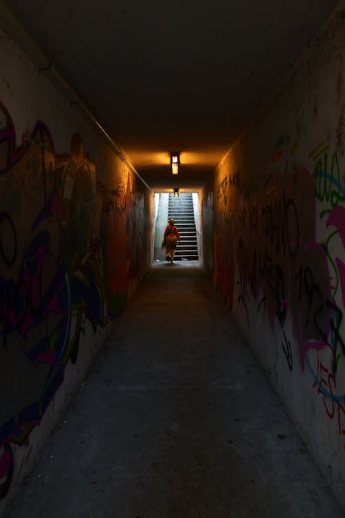 Person Walking on a Underground Hallway