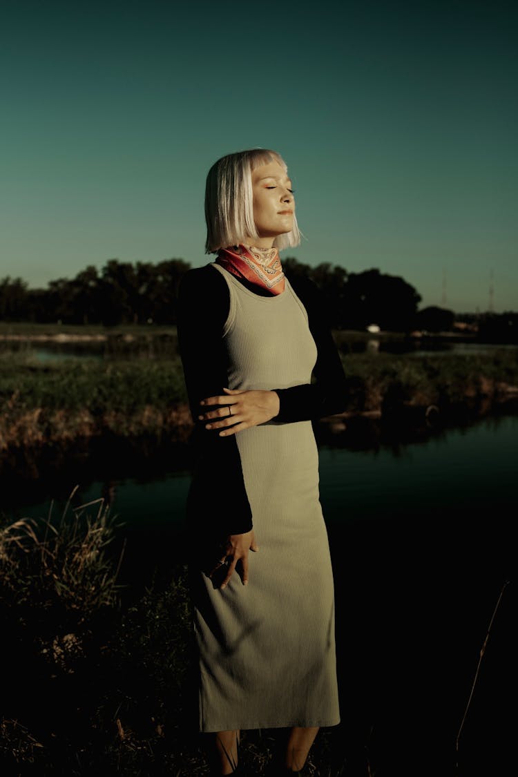 Woman With Platinum Hair Posing Near A River 