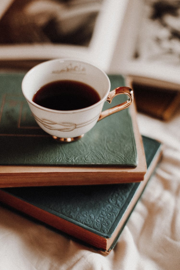 Close Up Of Coffee Cup And Books