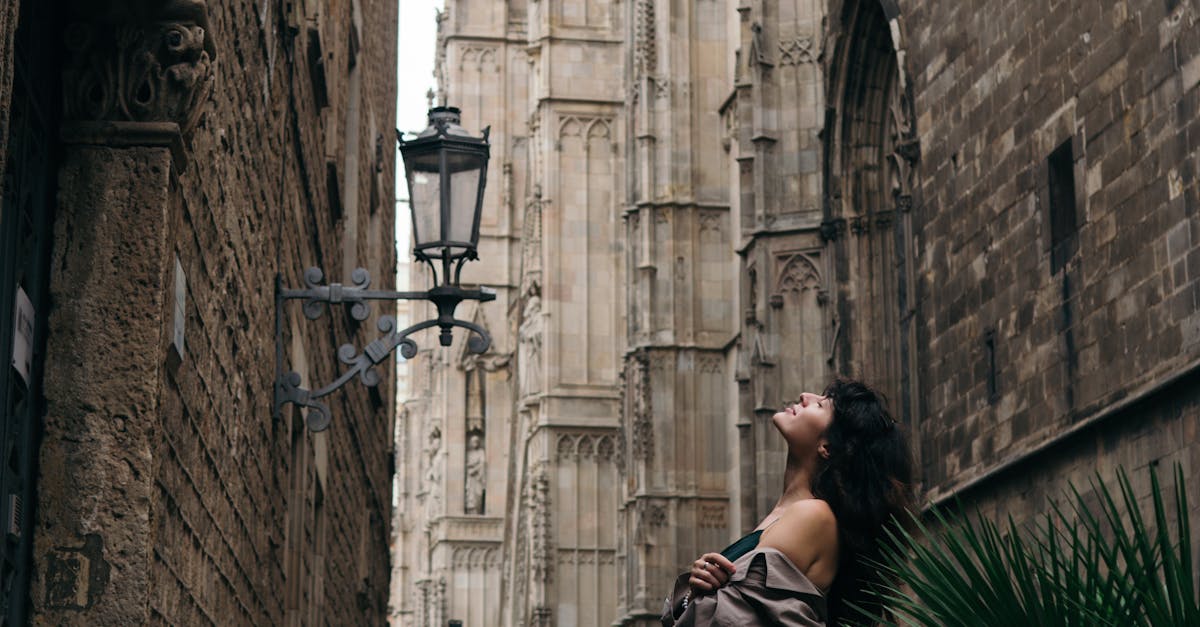 Woman Leaning on Railing in City Alley · Free Stock Photo