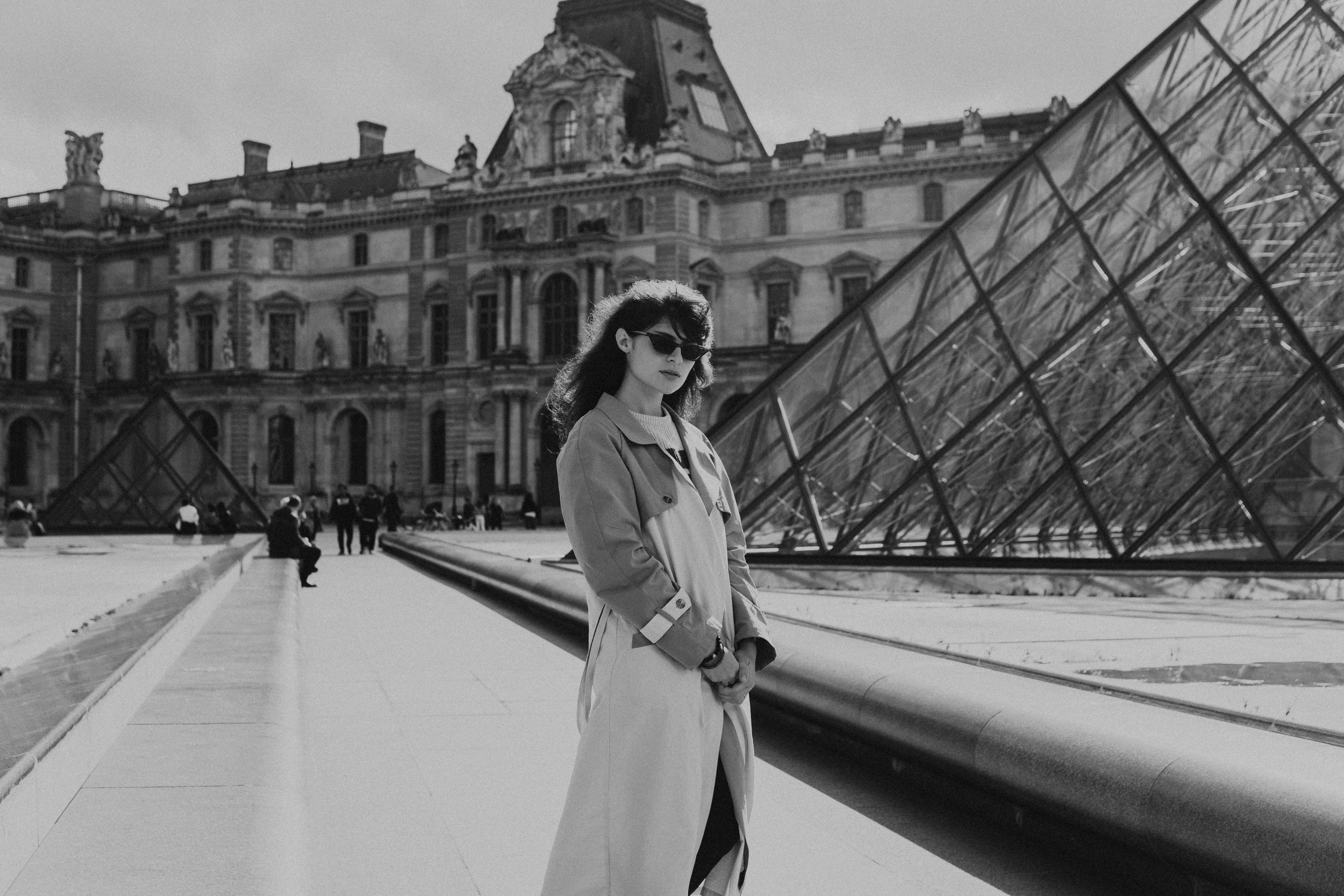 young woman in front of louvre paris france