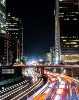 Vibrant night cityscape of Mexico City with dynamic light trails and modern skyscrapers.
