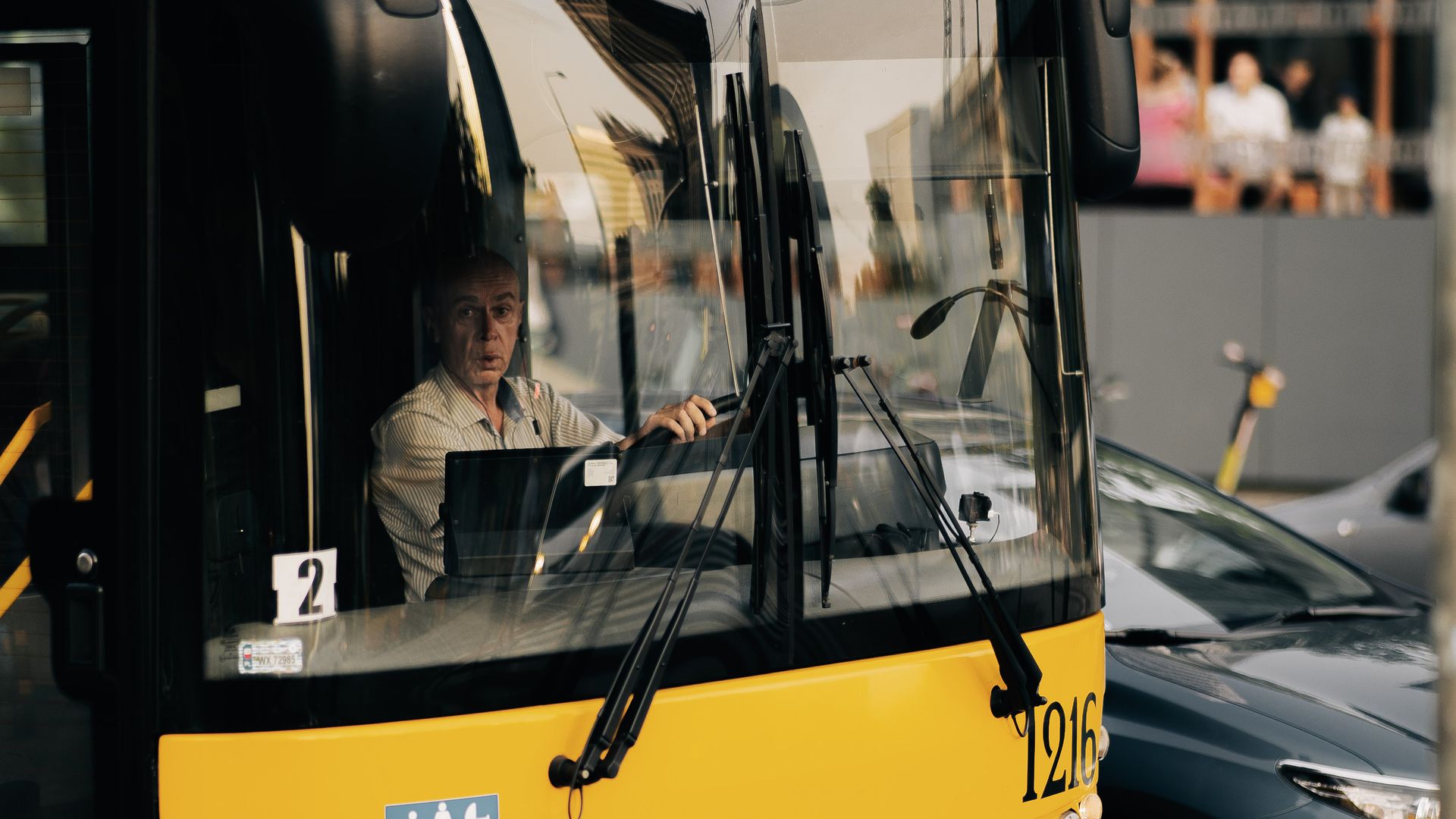 A professional bus driver navigating through city streets. Urban transportation scene.